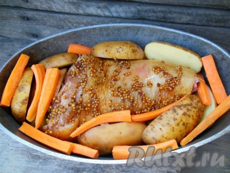 Утятницу (или другую жаропрочную толстостенную ёмкость) смажьте растительным маслом. На дно утятницы выложите слой картофеля, затем - свиную рульку. Рядом разложите морковь и оставшуюся картошку. Сверху полейте оставшимся медово-горчичным соусом.
