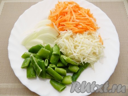 Приготовить овощи. Лук нарезать полукольцами, морковь и сельдерей натереть на терке. Если фасоль замороженная, ее можно не размораживать.  