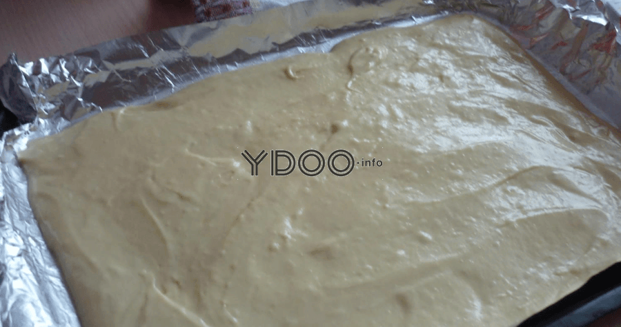 бисквитное тесто в форме для выпекания, застеленной фольгой
