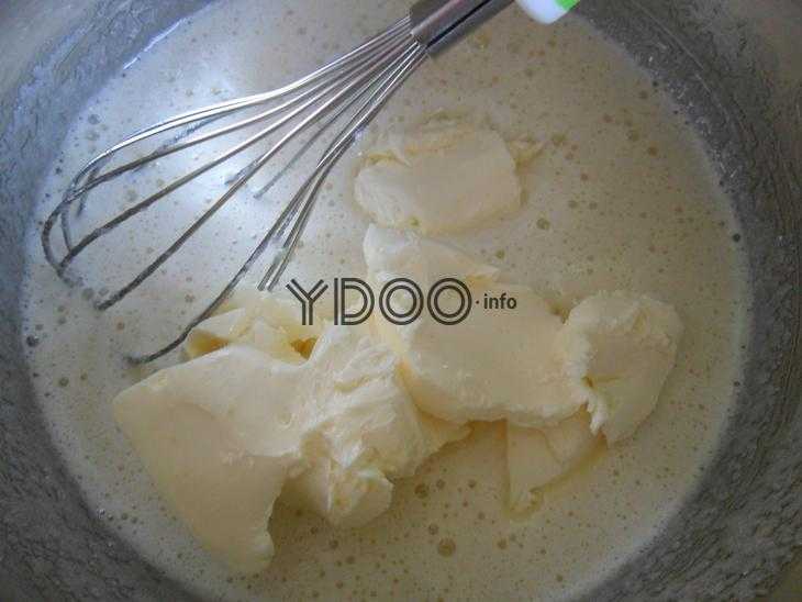 взбитые яйца с размягченным сливочным маслом в миске с венчиком