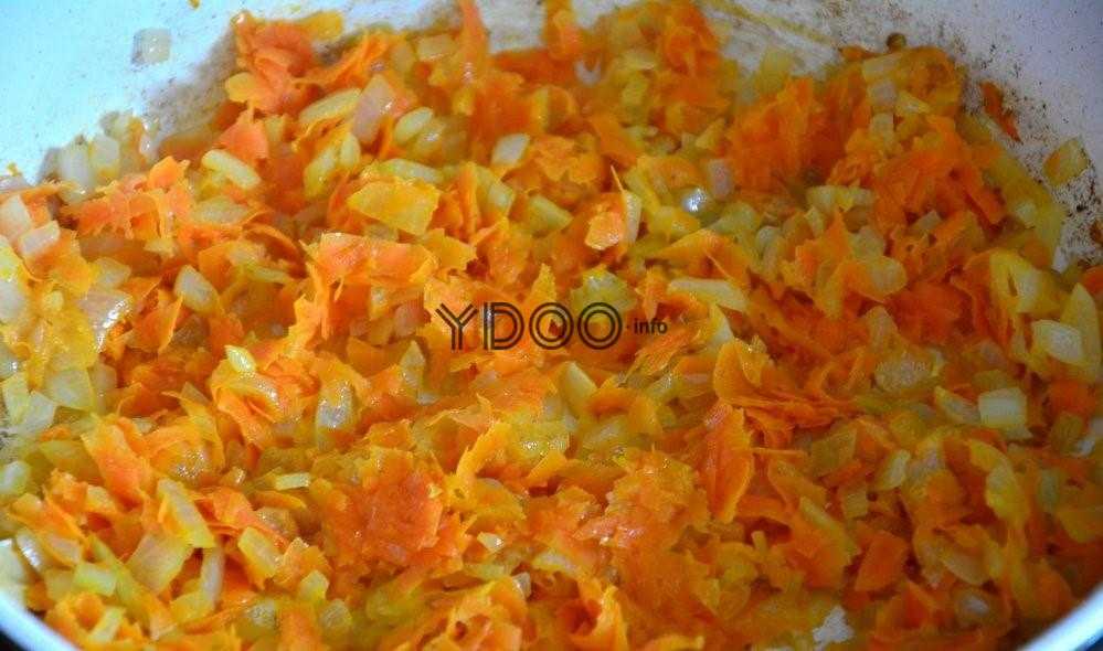 морковка и лук в сковороде, обжаренные на сливочном масле, до золотистого цвета