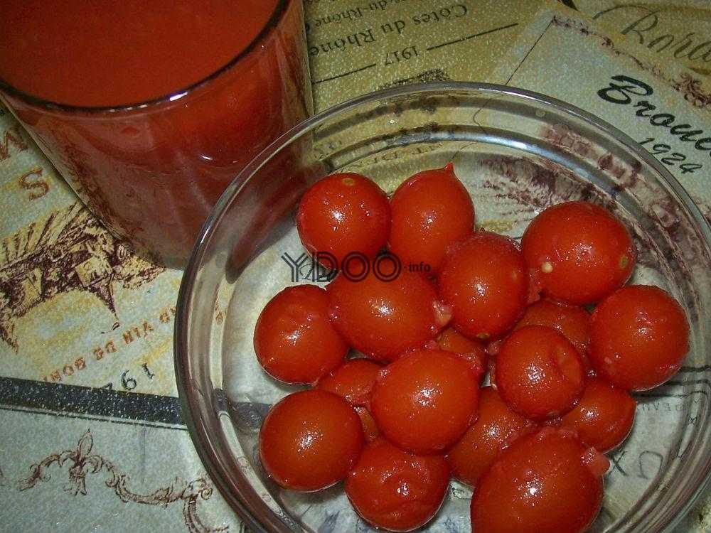 консервированные томаты в стеклянной миске на столе, рядом стакан томатного сока