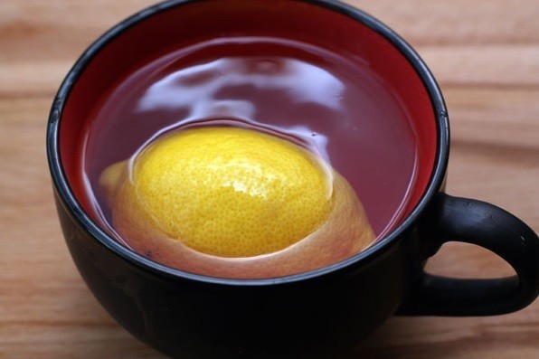 целый лимон, покрытый кипятком, в чаше на столе