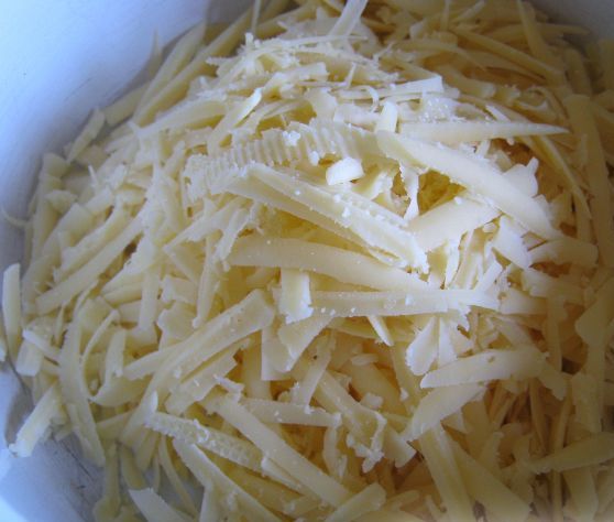 тертый твердый сыр в миске